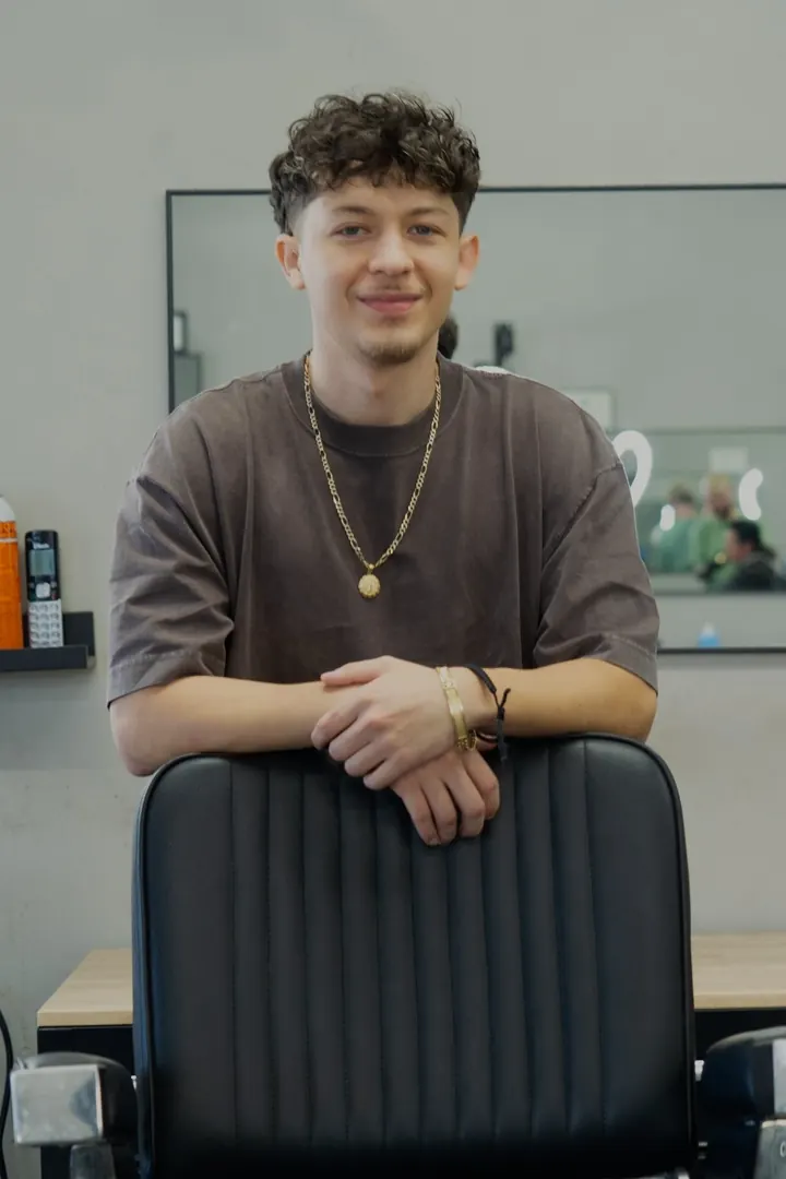 Edgar behind the chair