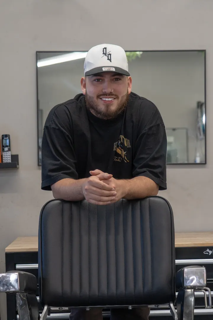 Luis Pena behind the chair